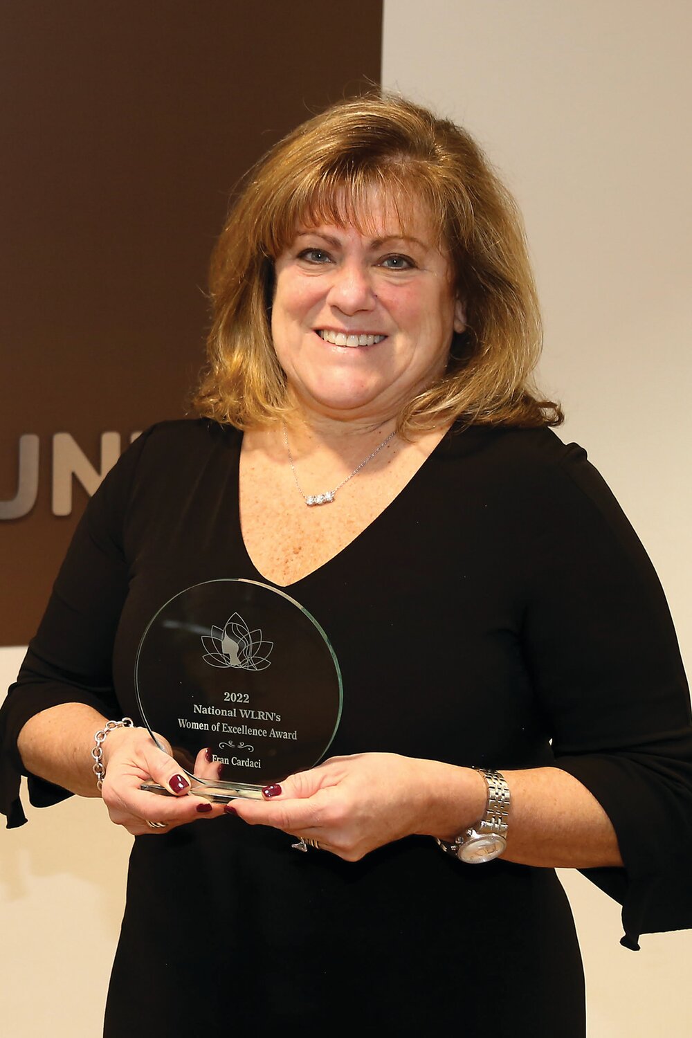 Fran Cardaci holds her 2022 YUSA National Women of Excellence Award.
