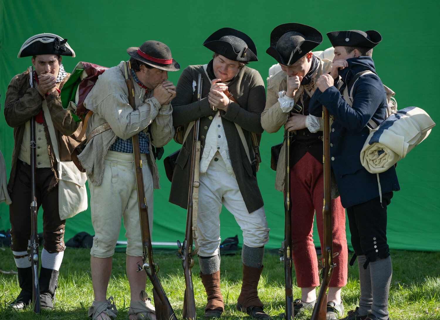 Actors try to look cold while filming a winter scene in front of a green screne on a mild mid-April afternoon at Washington Crossing Historic Park.