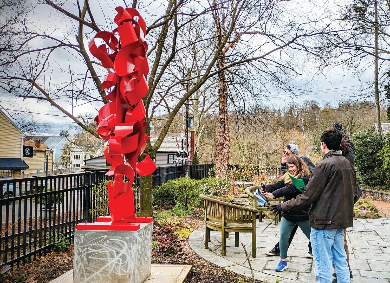 Visitors look at an outdoor sculpture in New Hope, part of the NHA Public Arts Program.
