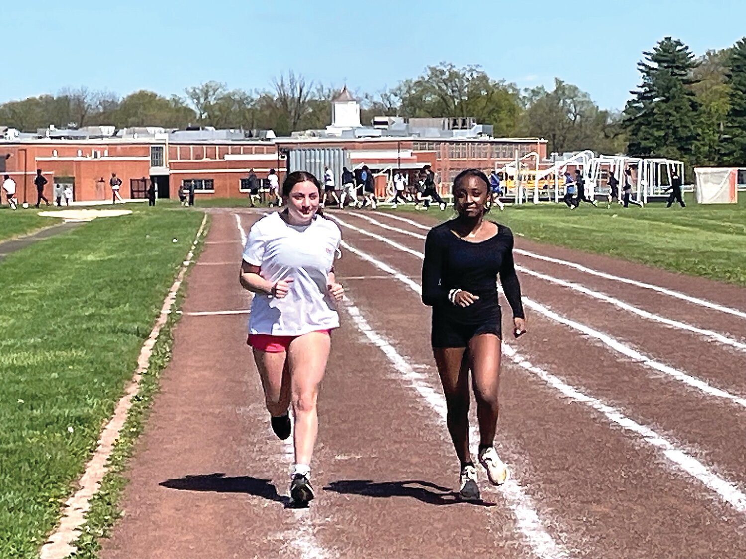 Hannah Avondoglio, left, and Mariah McKoy warm up for Monday’s practice at William Penn Middle School in Yardley.