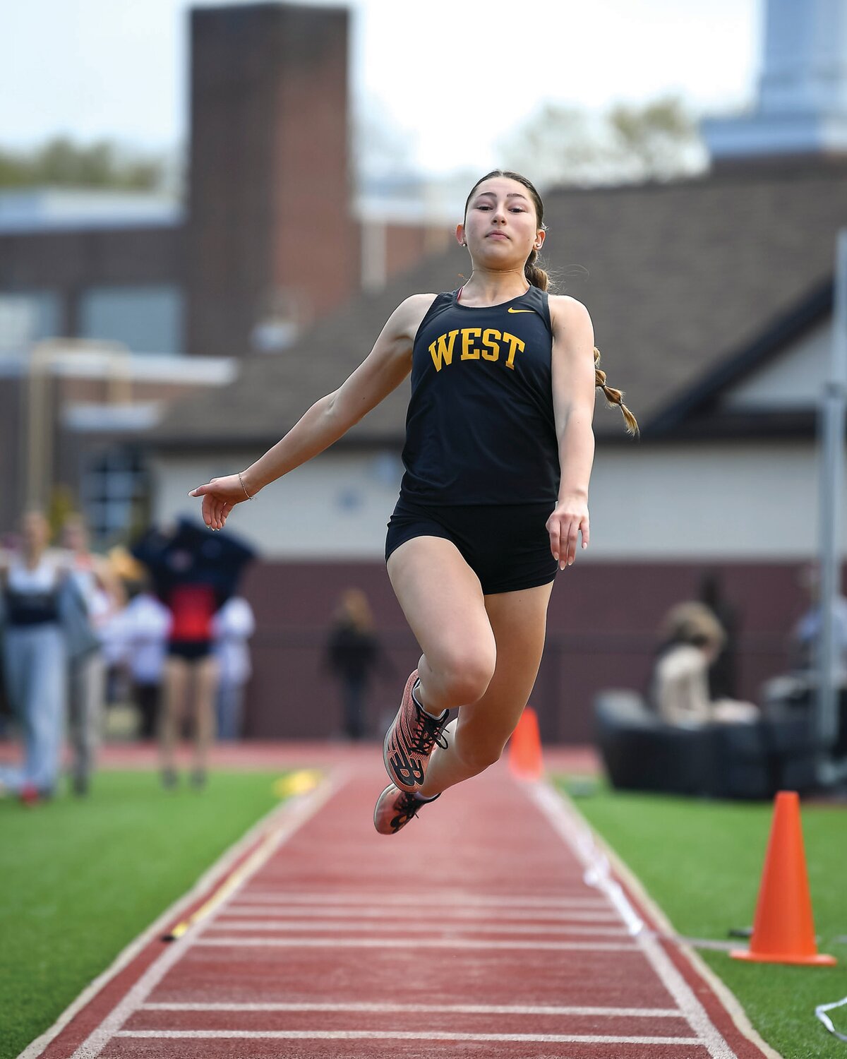 CB West’s Mia Menard competes in the girls triple jump.