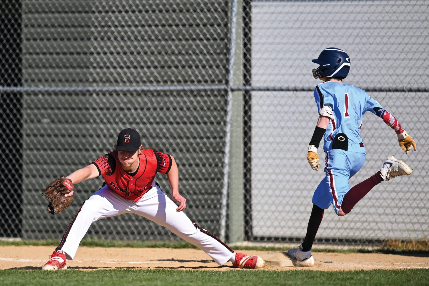 Plumstead Christian first baseman Matt Earl stretches out to just get Faith Christian’s Ethan Johnson in the fifth inning.