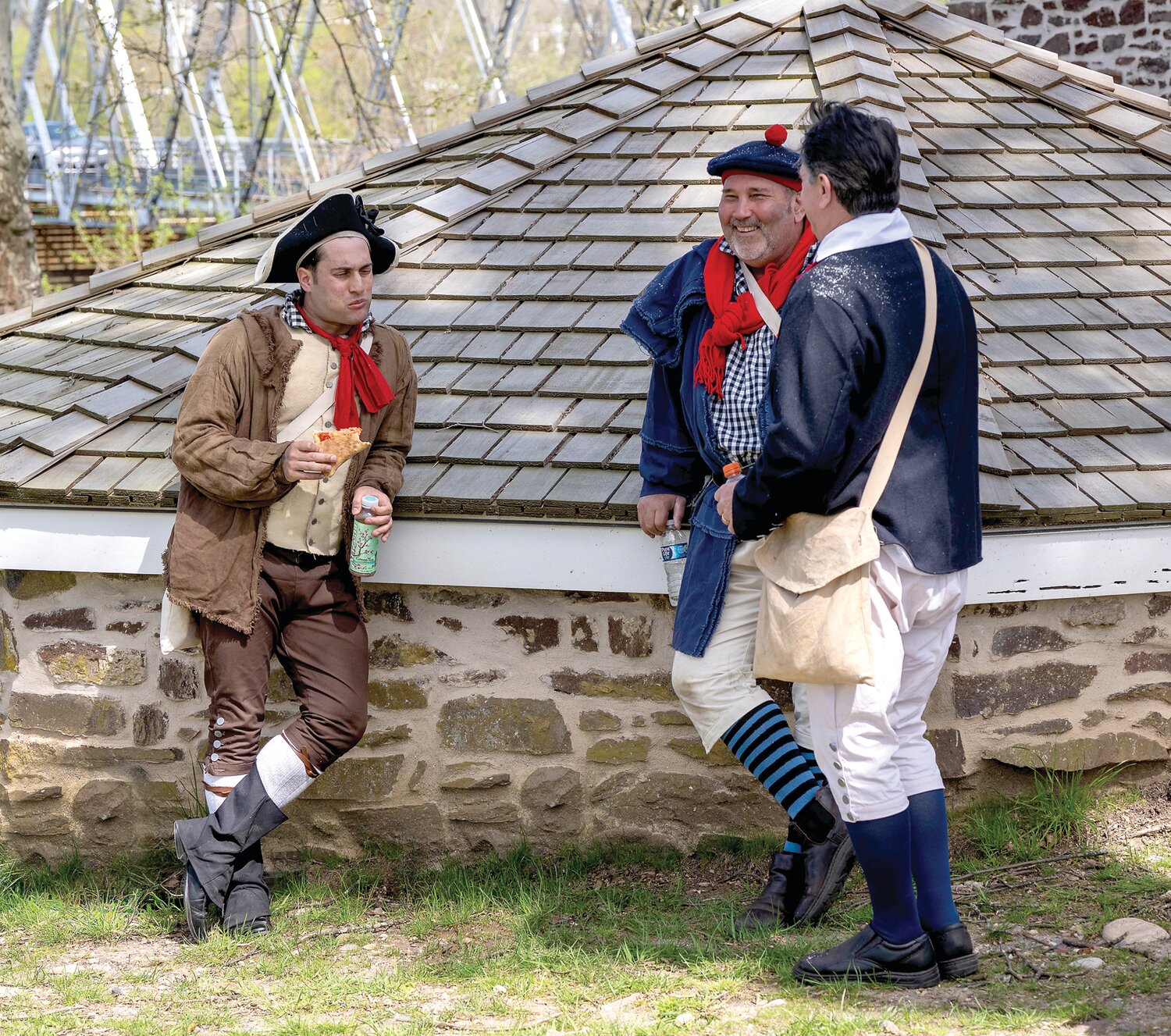 A reenactor has some pizza and an Arizona iced tea during a break in the filming at Washington Crossing Historic Park.