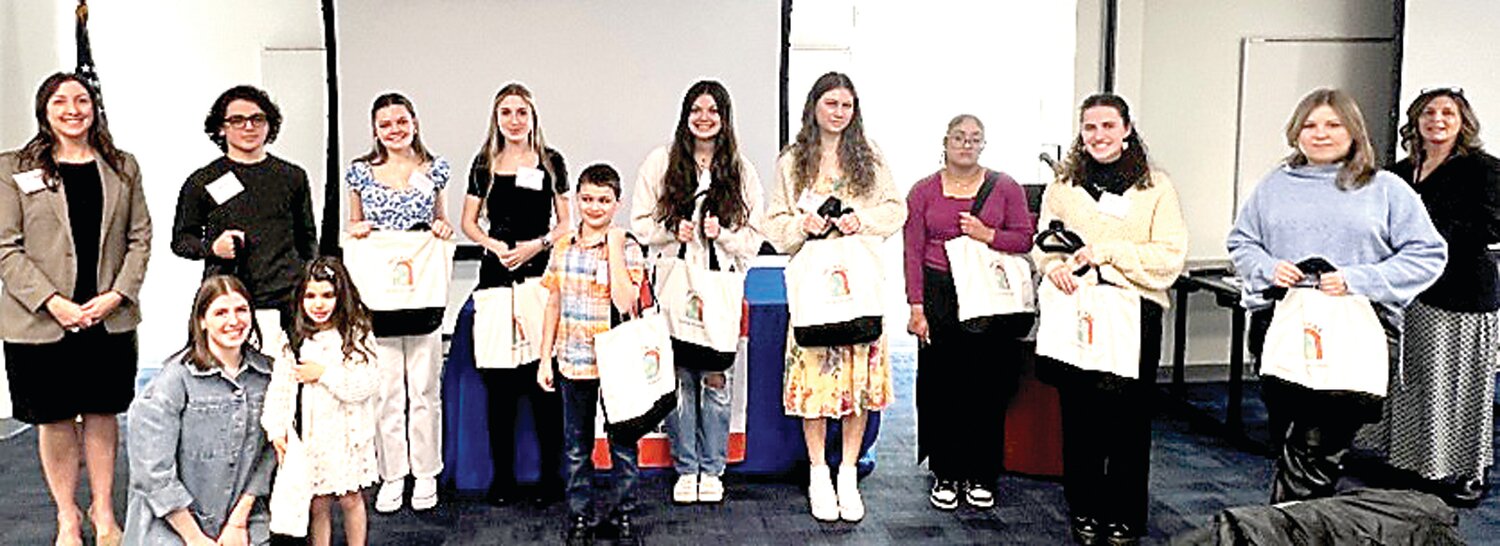 Students who were able to attend the Bucks County Intermediate Unit Student Art Gallery reception hold art bags provided through a collaboration with the Michener Art Museum.