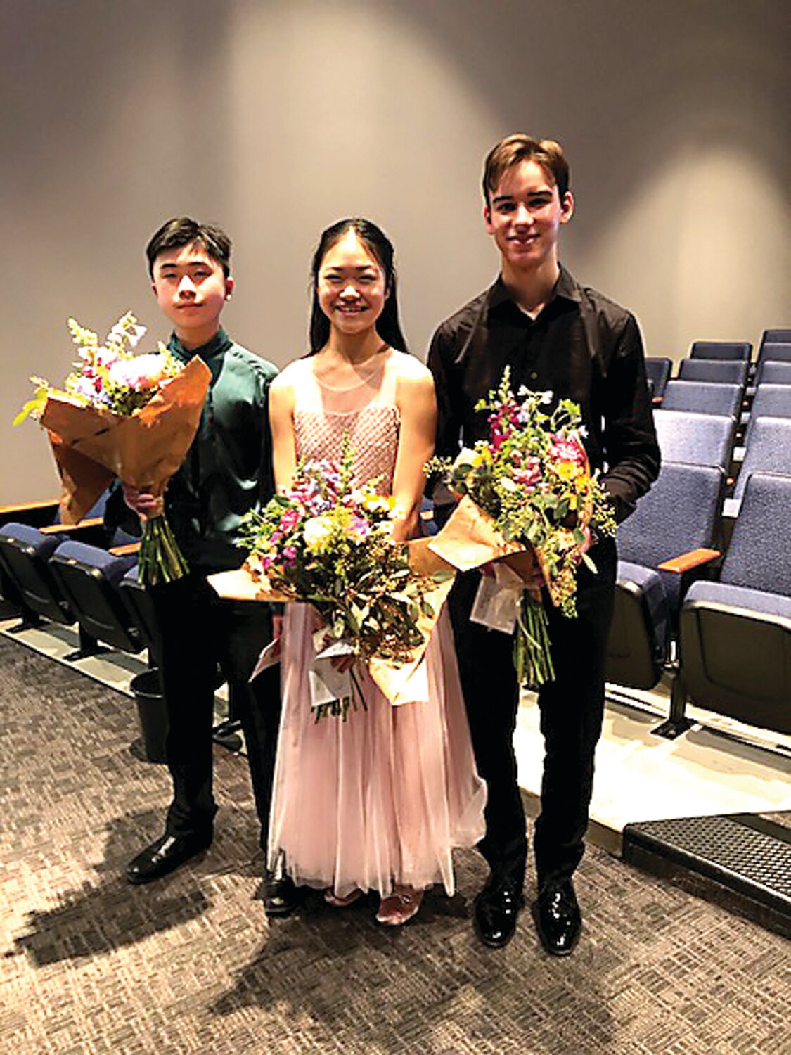 Elizabeth “Poppy” Song, 14, first prize winner of the 2024 Caprio Young Artists Competition, center, with Noah Ferris, 17, second prize winner, right, and Kwanyun Loo, 13, third prize winner, left.