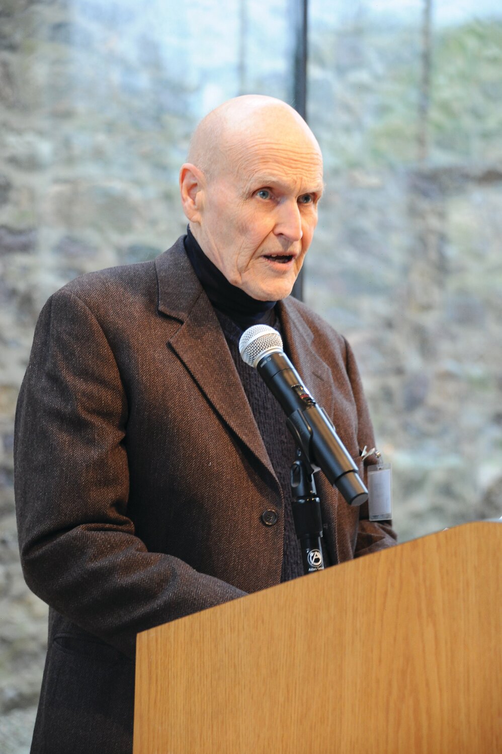 Sculptor George Anthonisen delivers remarks during the exhibition opening.