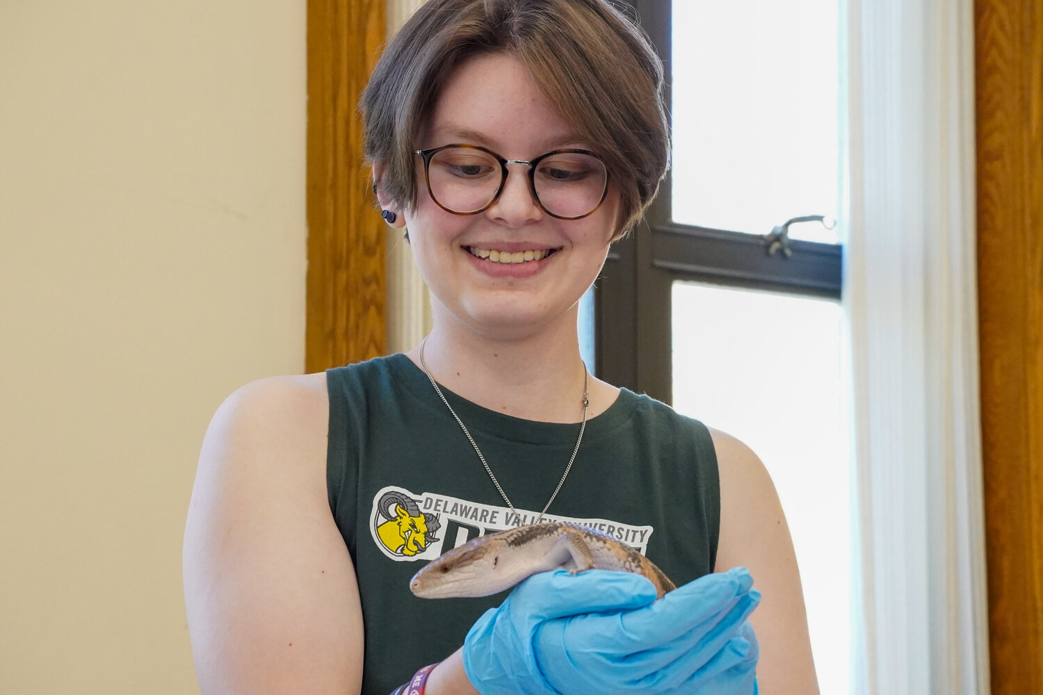 Mackenzie Connery holds a skink during a small animal educational event at the Krauskopf Memorial Library during A-Day at Delaware Valley University.