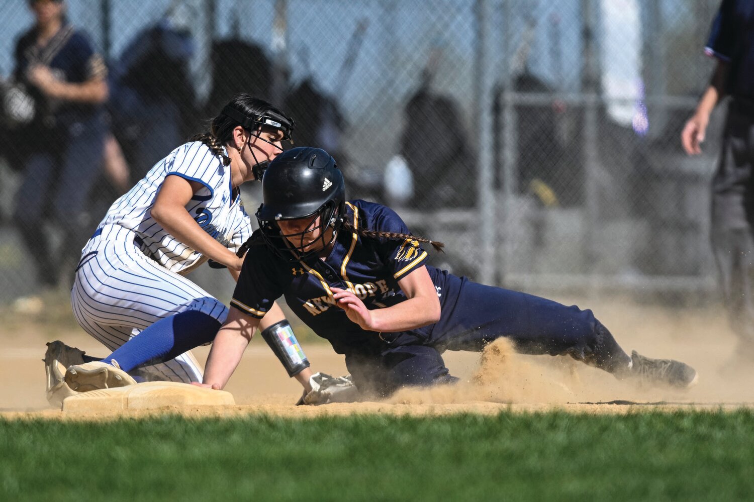 New Hope-Solebury’s Emily Wilson avoids a tag from Quakertown’s Kira Jefferson and hurries back to second after an infield out.