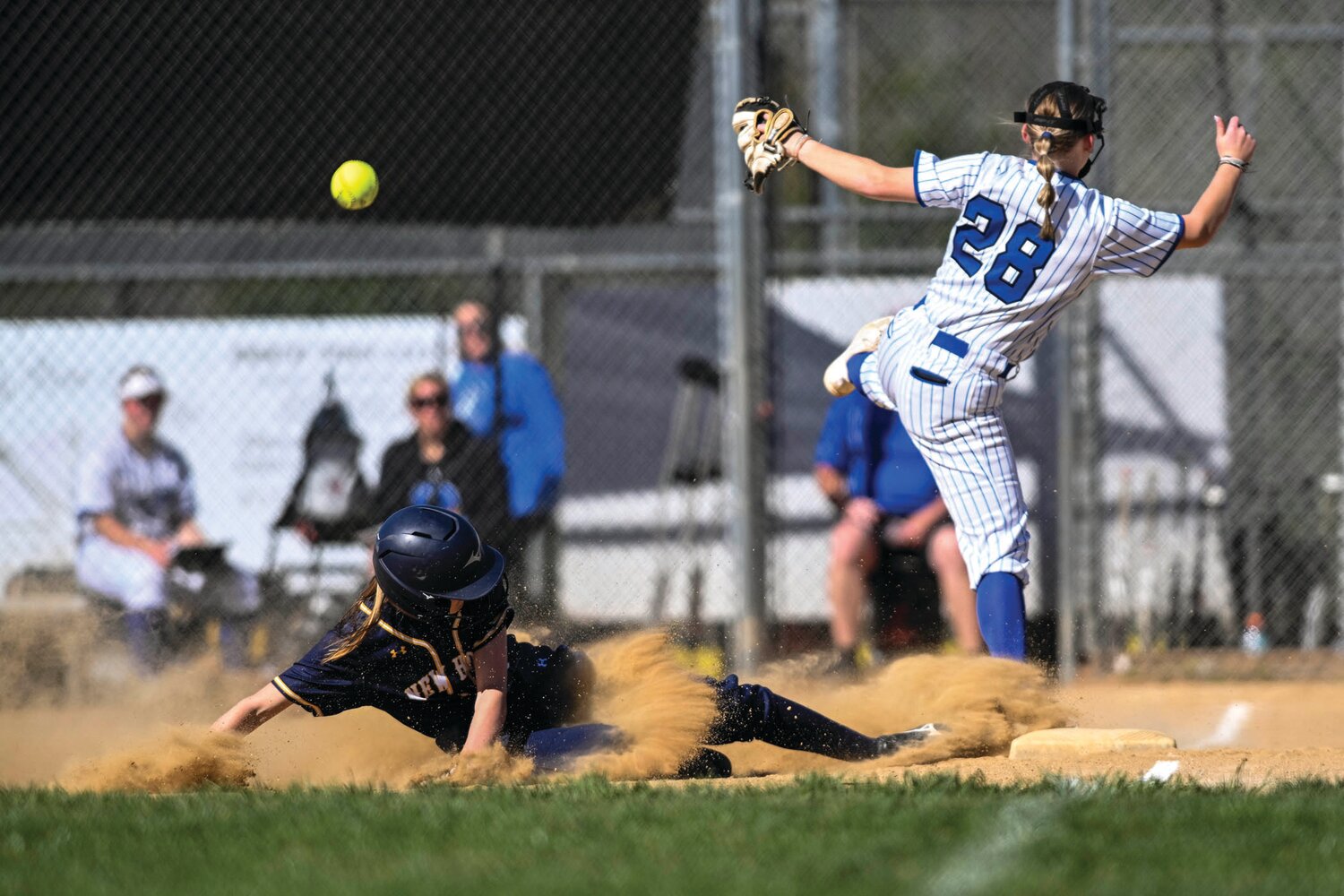 Stealing third base in the third inning, New Hope-Solebury’s Kaylee Harris slides ahead of the throw to Quakertown’s Elisabeth Stout.