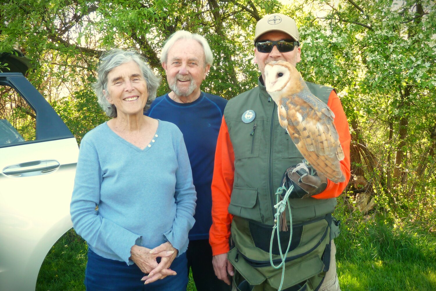 Jeanne Bray and Jim Bray stand with Gregory Wojtera and the barn owl.