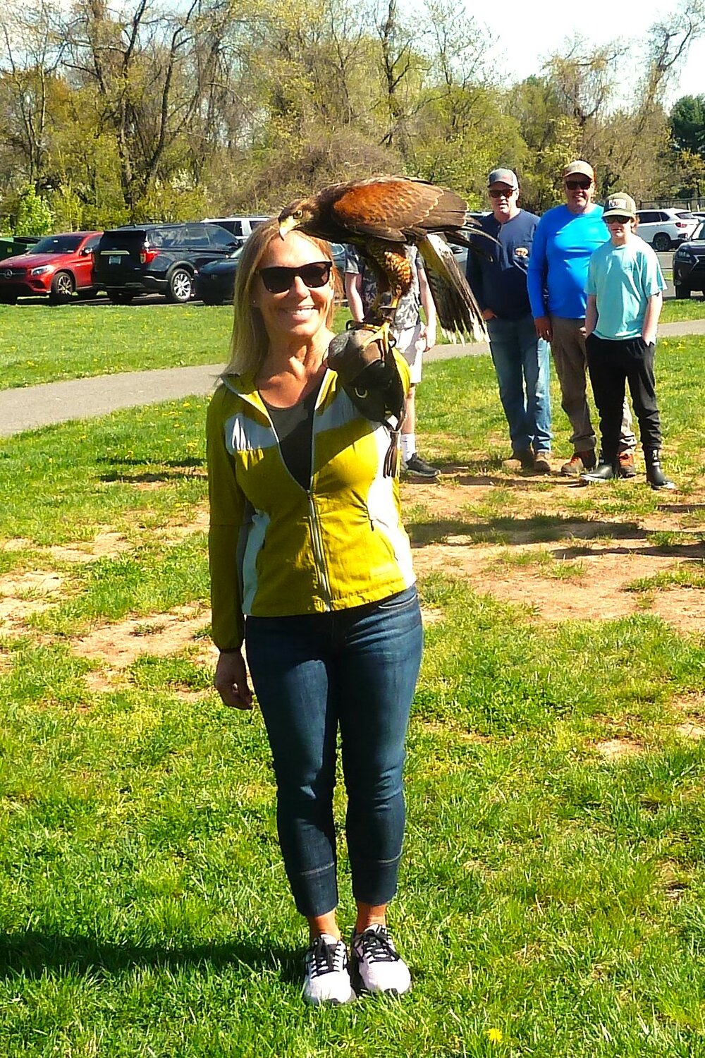 Loretta Lewis meets the Harris’s hawk at Memorial Park.