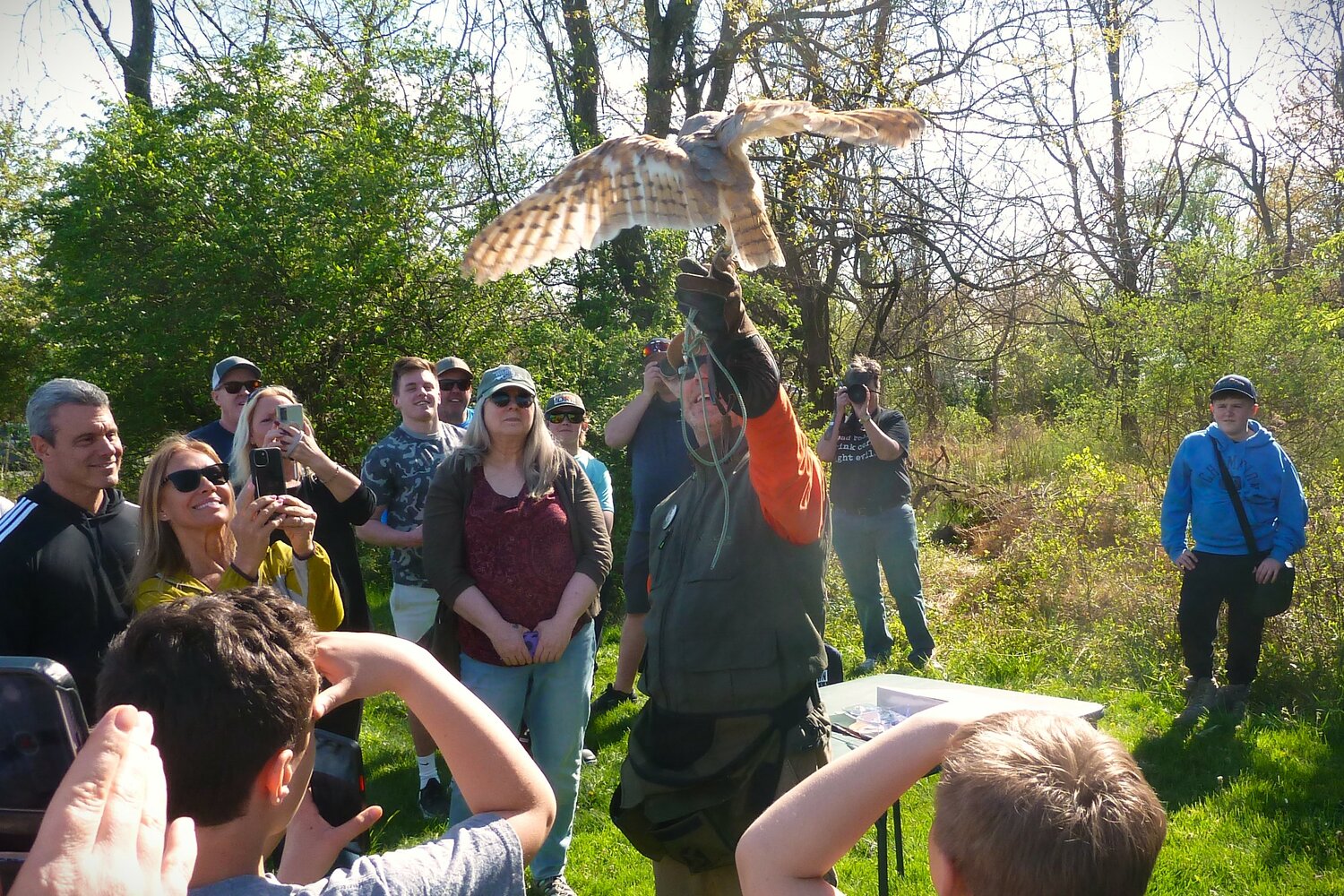 Master Falconer Gregory Wojtera shows the crowd a barn owl.