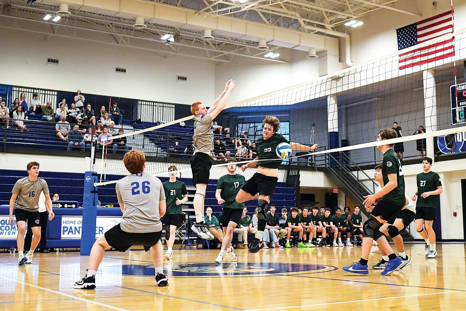 Pennridge’s Bryce Ammon slams the point in front of the block of Quakertown’s James Conner.