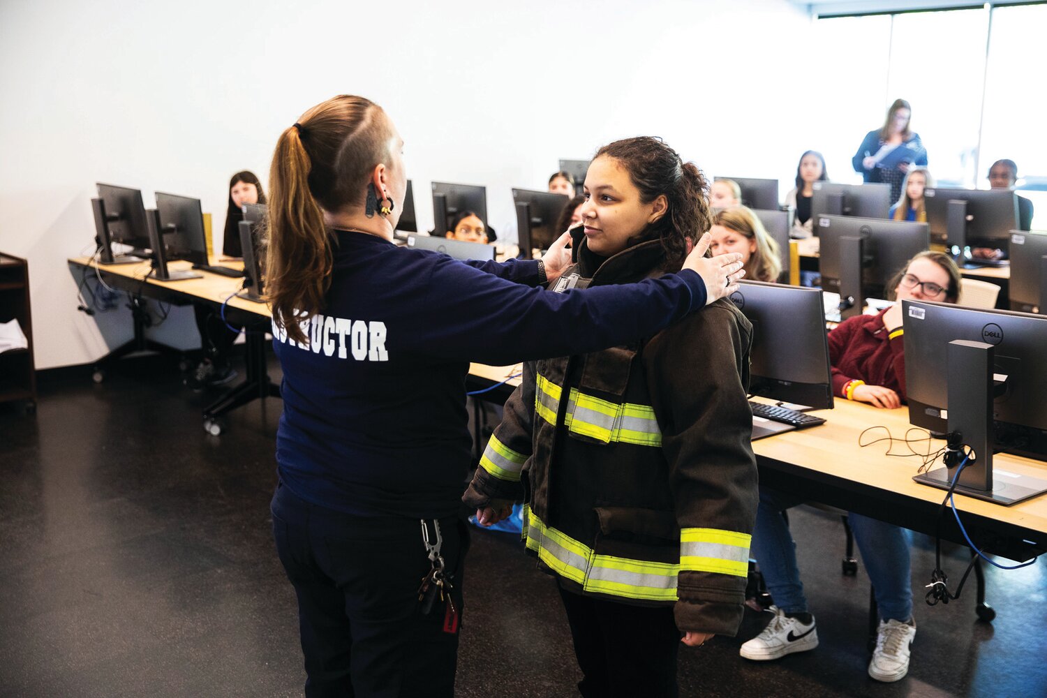 A Bristol Township School District eighth grader tries on firefighter gear.