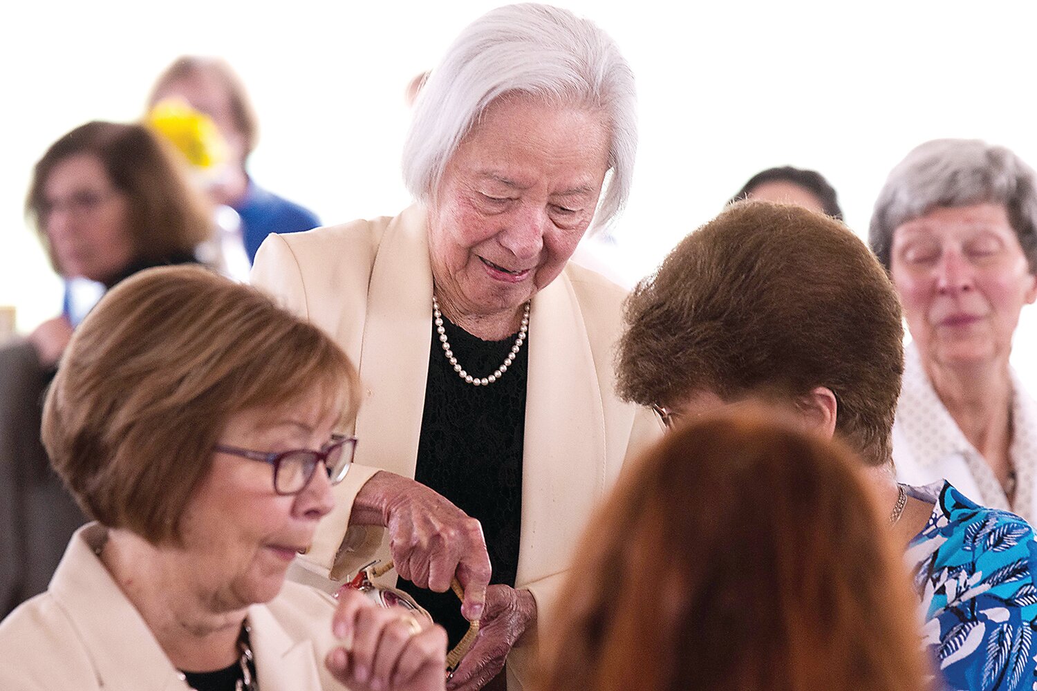 Salute to Mothers Scholarship Tea founder Betty Tsai pours tea for guests.