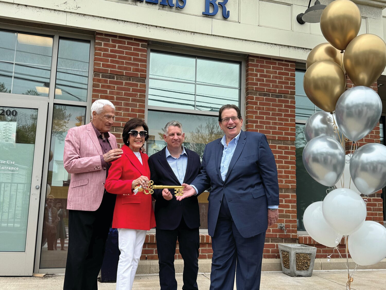 From left are Harvey and Madalyn Rovinsky, turning over the ceremonial key to new Bernie Robbins Jewelers owners Stephen Berman, based in the Newtown store, and Steve Jaffe, based in the Somers Point, N.J., store.