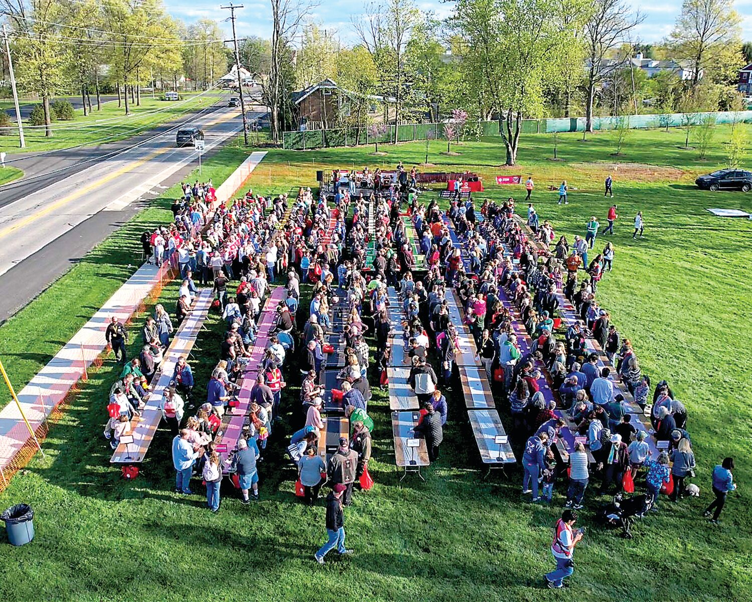 Participants gather in Plumstead Township for Tague Lumber’s recent successful attempt to break the Guinness World Records record for the most people simultaneously knocking on wood. The event saw an impressive turnout of 552 participants, surpassing the previous record of 295.
