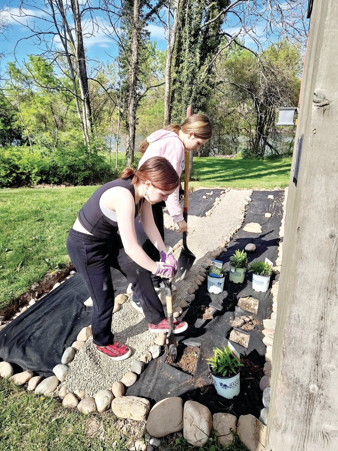 Girl Scouts Anna von Hohen and Chloe Radbill work on creating a pollinator garden at Washington Crossing Historic Park.