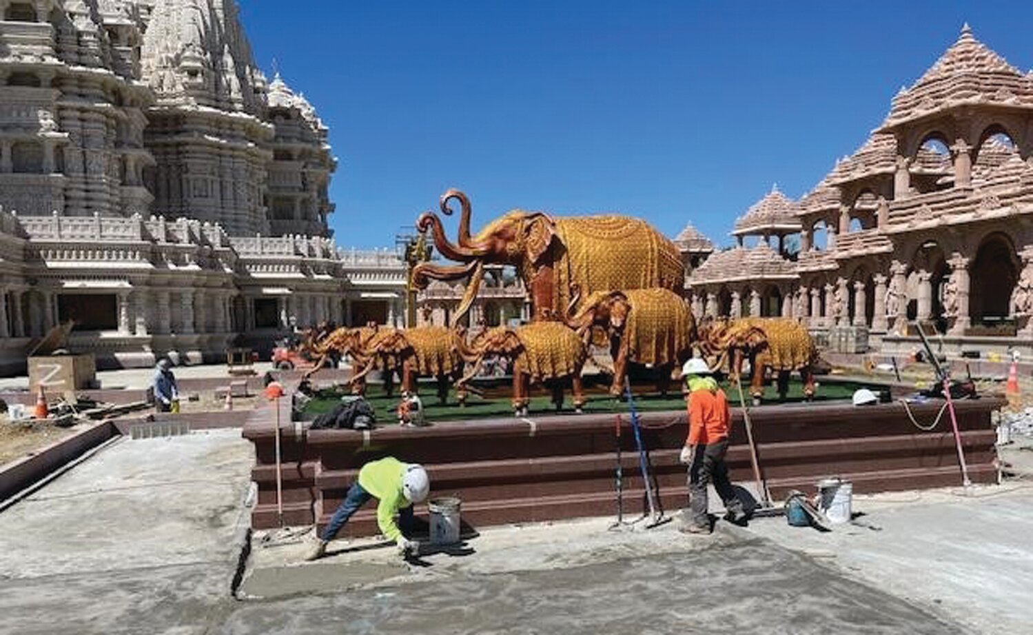 Construction work goes on near elephant statues. Hindus value the animals for their loyalty and kindness.