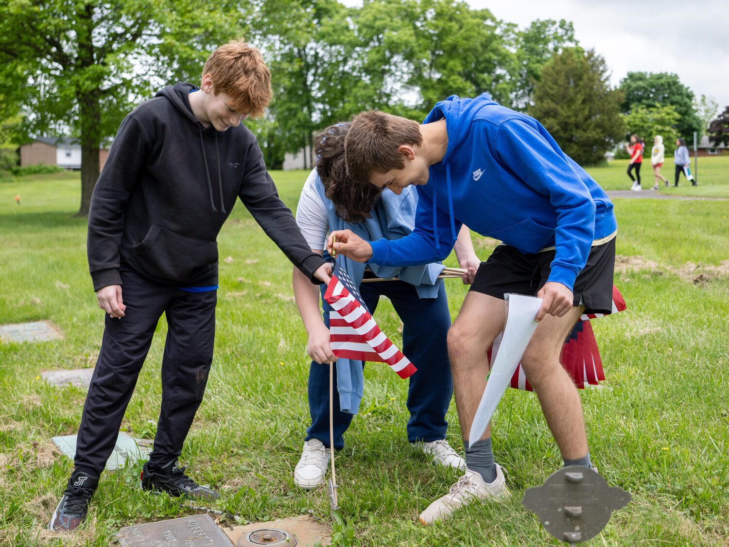 Students Mason Forrester, Lachlan Bradley and Boston Gower spent May 16 preparing veterans’ graves for Memorial Day in Perkasie.