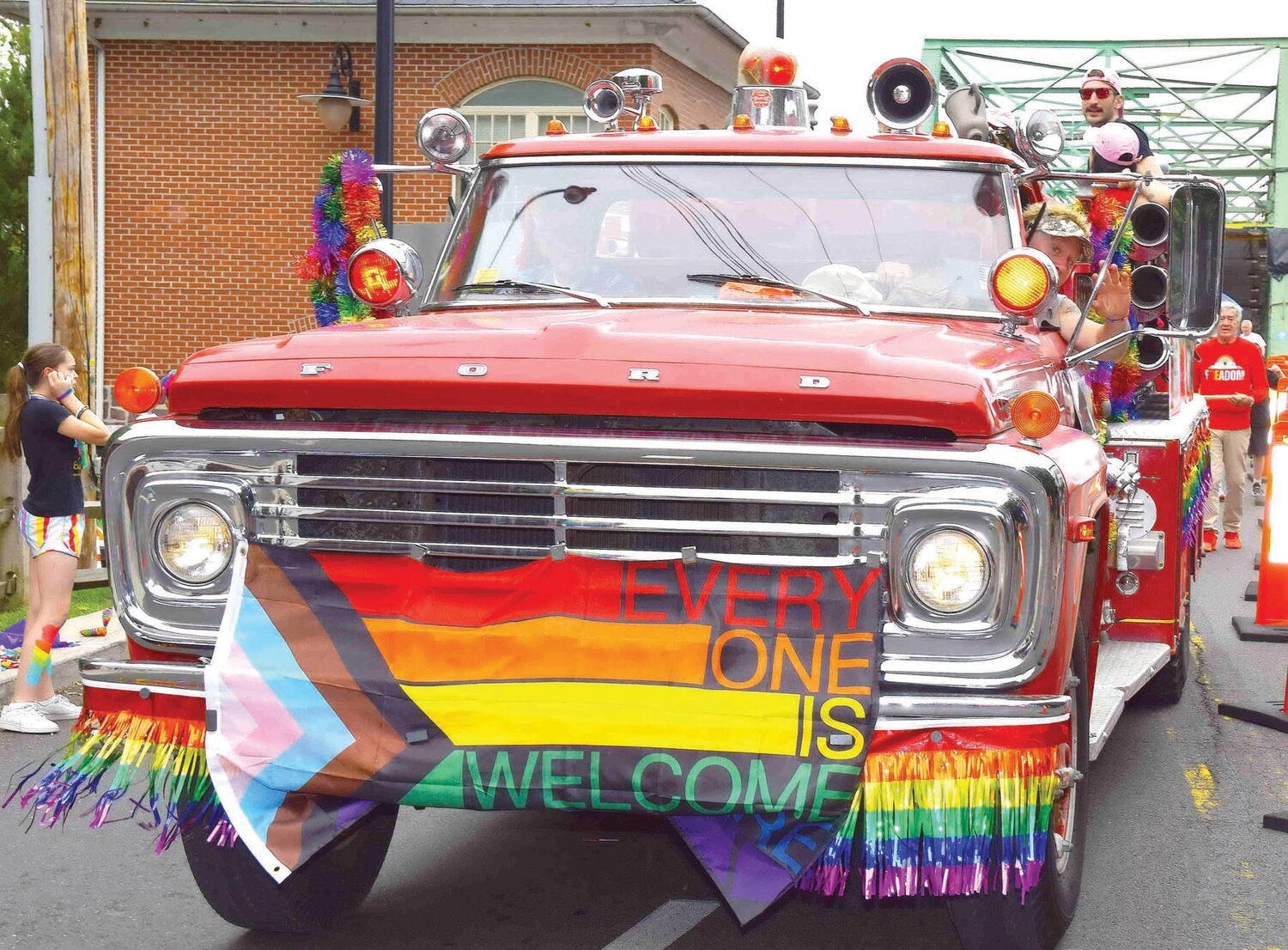 Participants in the Pride Parade cross the bridge into New Hope.