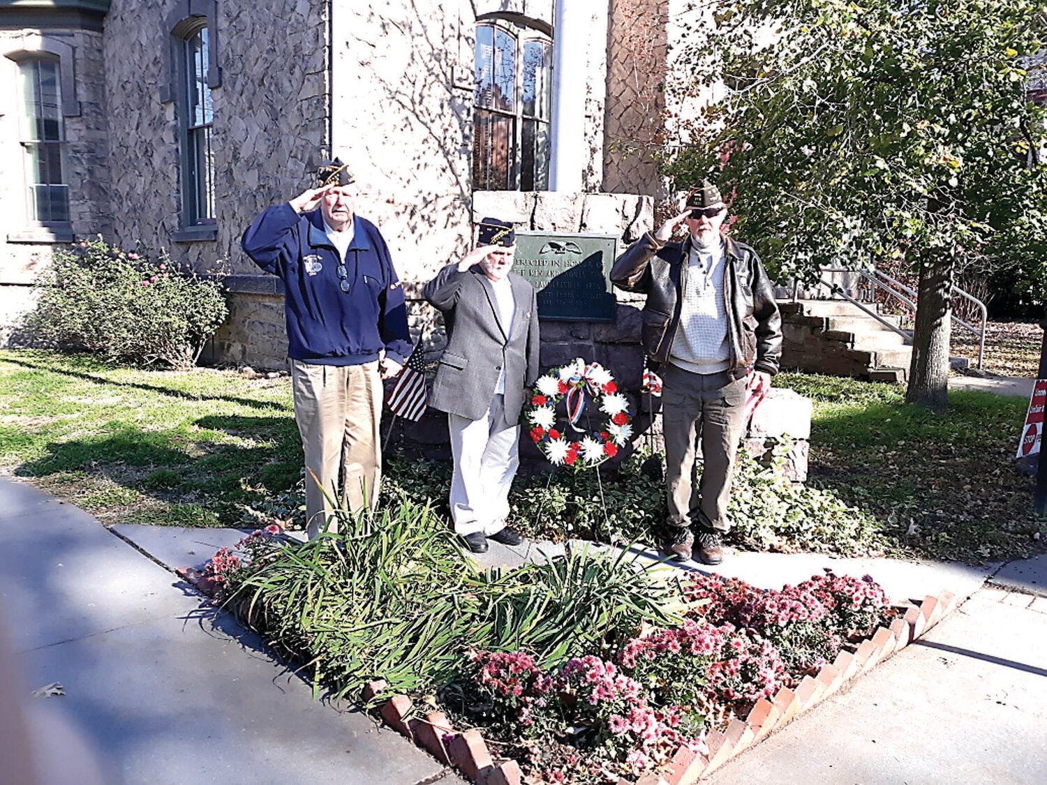 (From left) 2024 Memorial Day Parade co-Grand Marshall John “Shavy” Shurts, past Legion Commander Norb Rosso, VFW Post 7921 Commander and Memorial Day Parade organizer Georg Hambach place the wreath for Veterans Day at Lambertville City Hall.