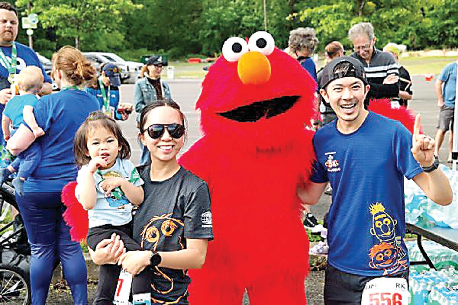 The Justin Woo family of New York City gets a chance to say hello to Sesame character Elmo during a meet-and-greet at Sunday’s Kiwanis-Herald Sesame Place Classic in Langhorne.