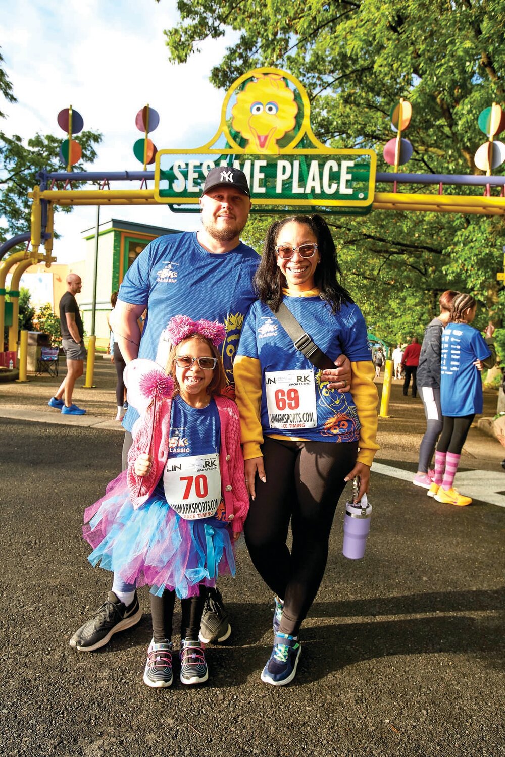 Ryan Bruce, wife Jasmine and daughter McKenzie of Old Bridge, N.J., participate in the Sesame Place Classic.