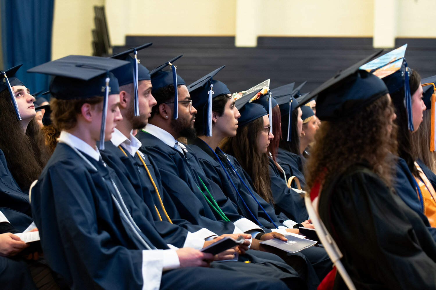 Graduates listen during their commencement ceremony at Bucks County Community College on May 16.