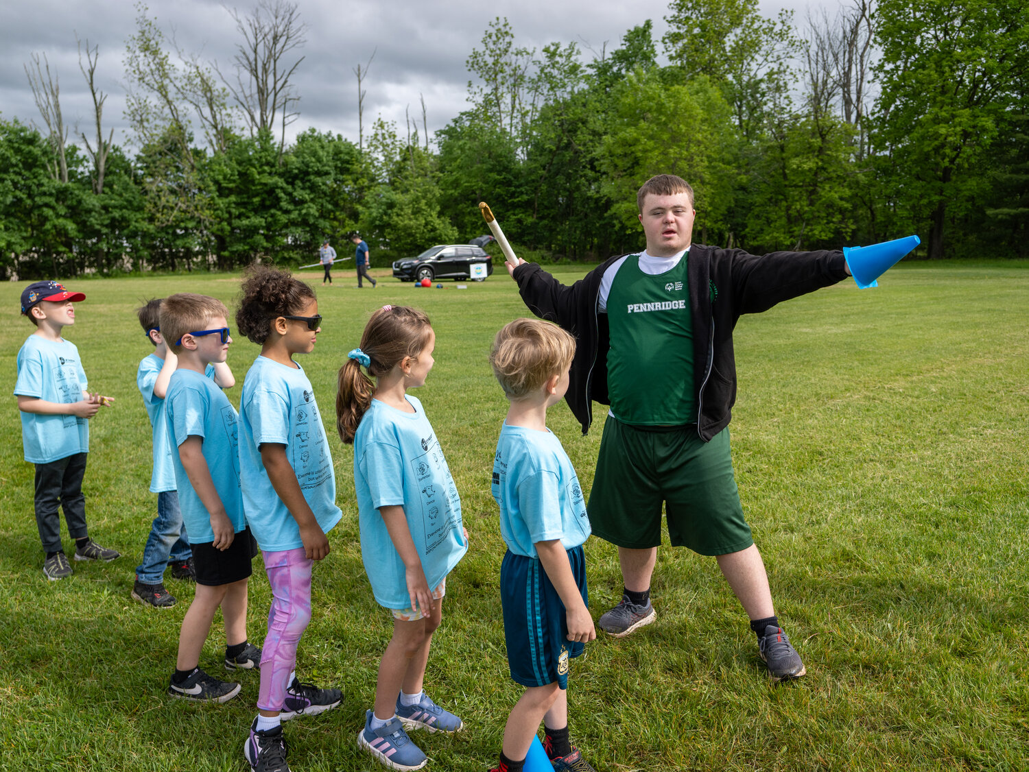 A member of the Pennridge Unified Track Team works with Sellersville Elementary School students at “Exercise for Education” on May 16.