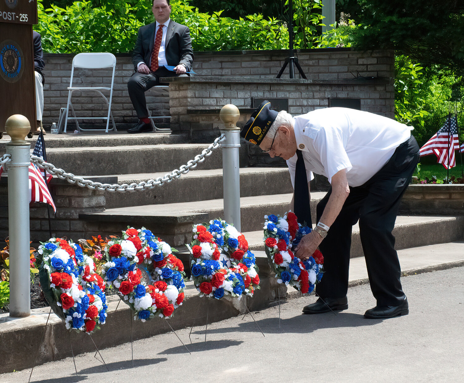 Former state Rep. Paul Clymer, an Army veteran, places a wreath during the ceremony.