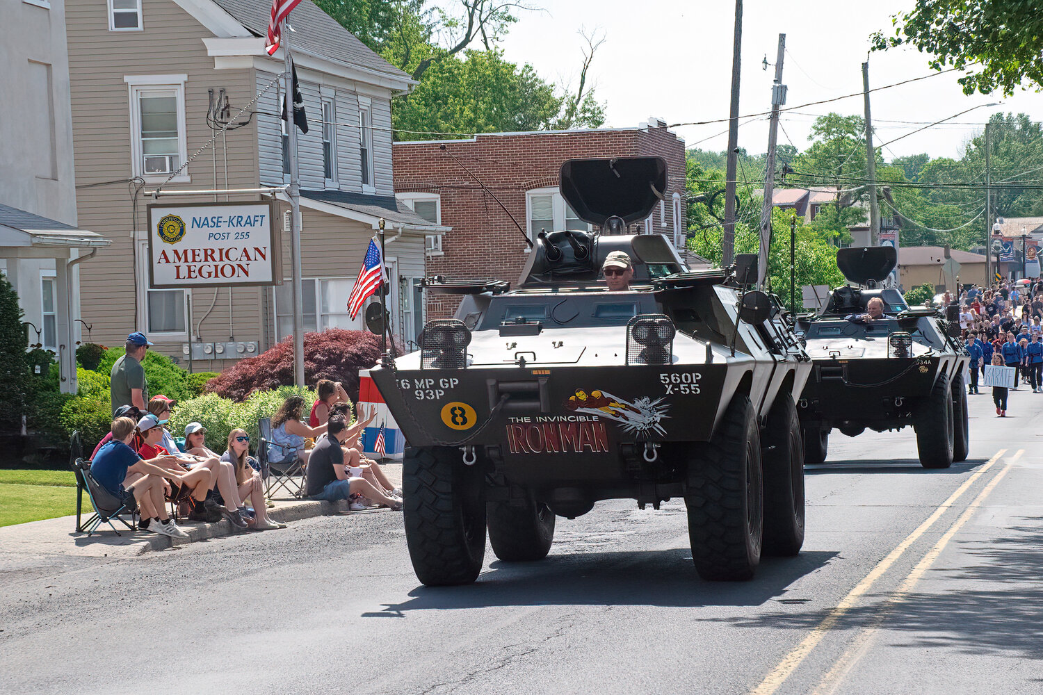 Military police tanks travel the parade route.
