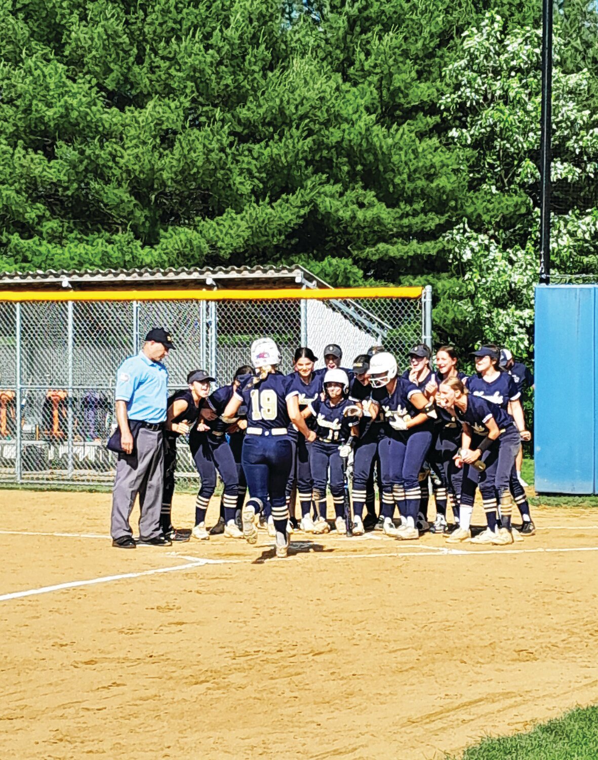 The Golden Hawks mob Council Rock South teammate Grace Stepp as she crosses home plate following her two-run home run in Tuesday’s District One PIAA playback against Central Bucks West.