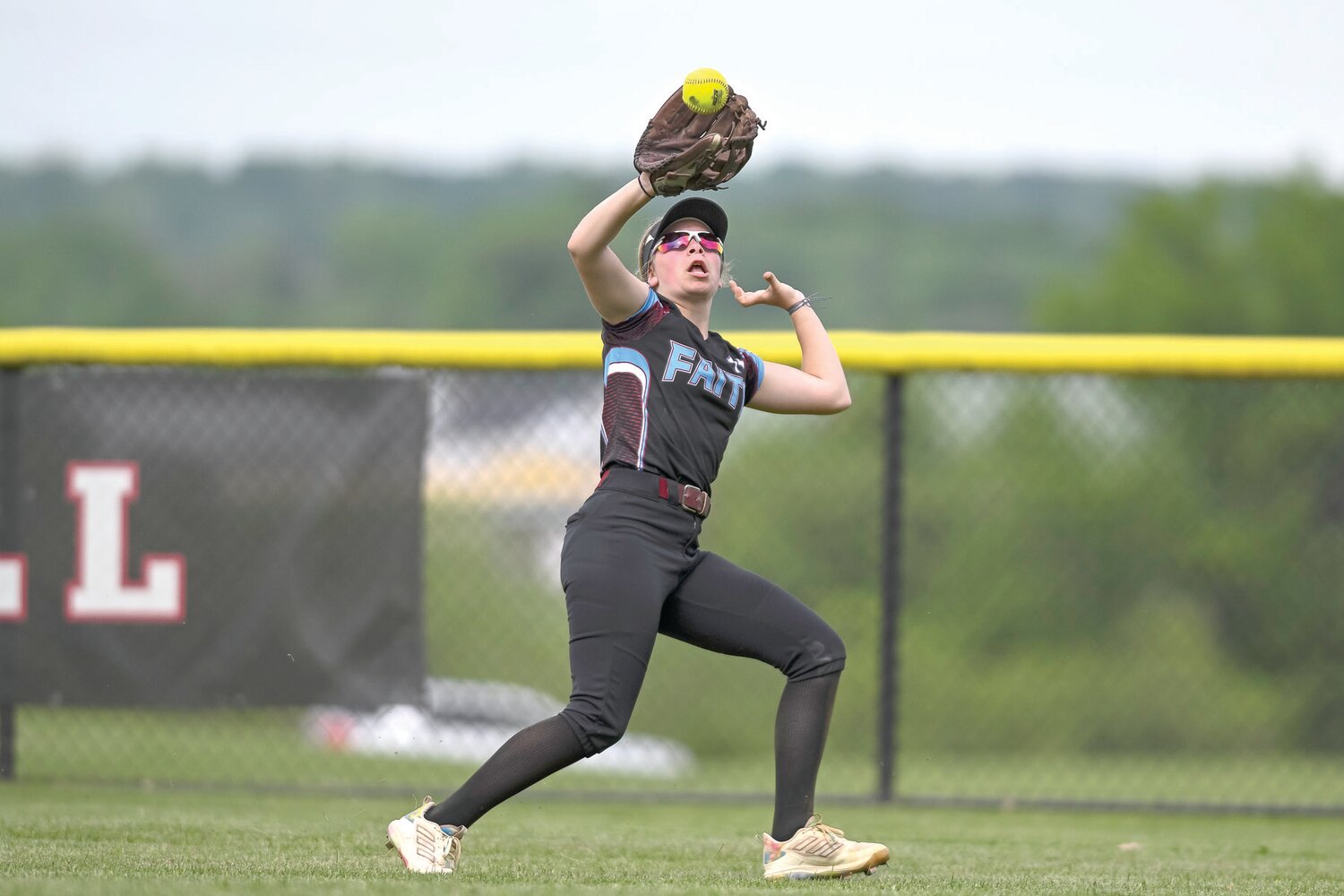 Faith Christian’s Lexi Reed tracks down a fly ball in the second inning.