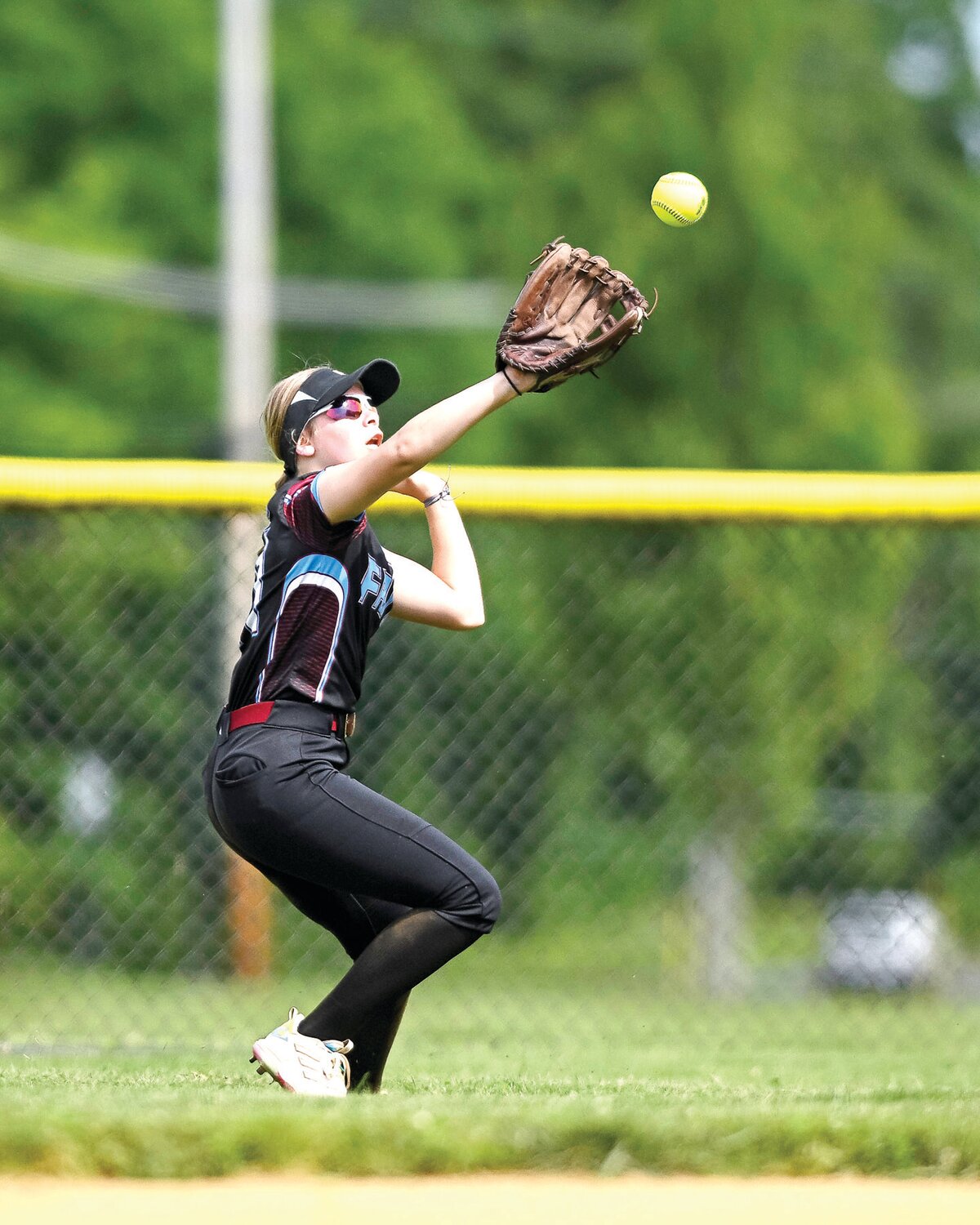 Faith Christian’s Lexi Reed makes a running catch during the bottom of the first inning.
