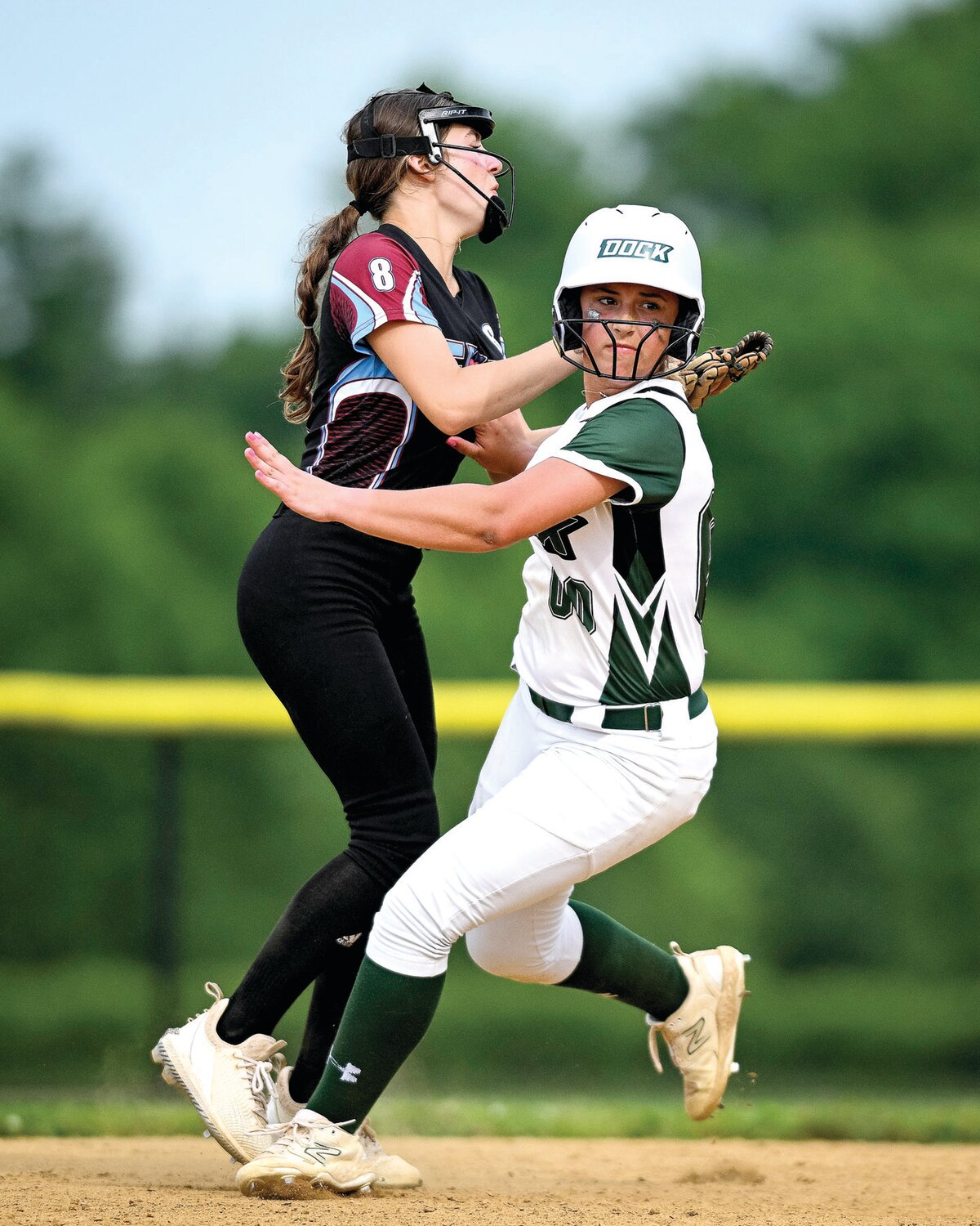 Dock’s Addison Landis and Faith Christian’s Cheyenne Greene collide while Landis rounds second base during the bottom of the third inning.