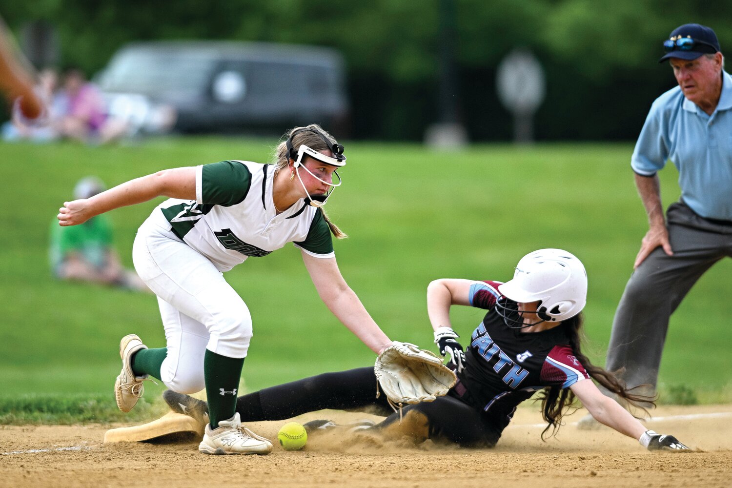 Faith Christian’s Sammy Synder slides into third base, beating the throw to Dock Mennonite’s Laura Charles during the fifth inning.