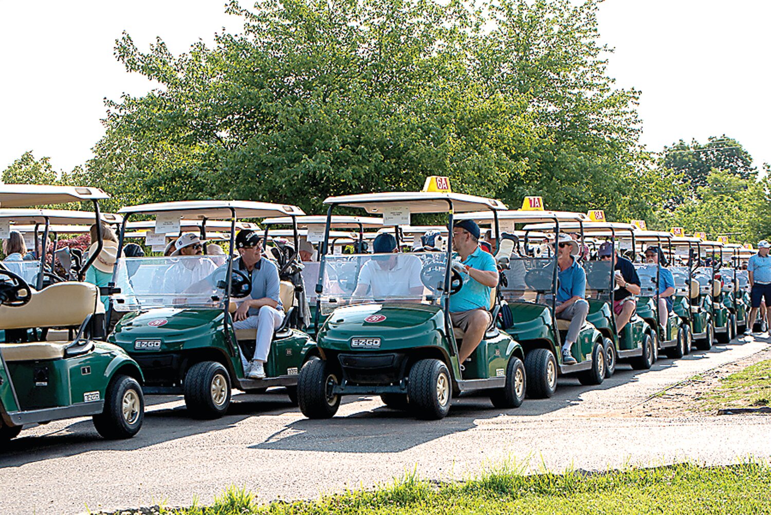 Golfers line up in their carts at the start of a previous Be Kind Kin Golf Classic.