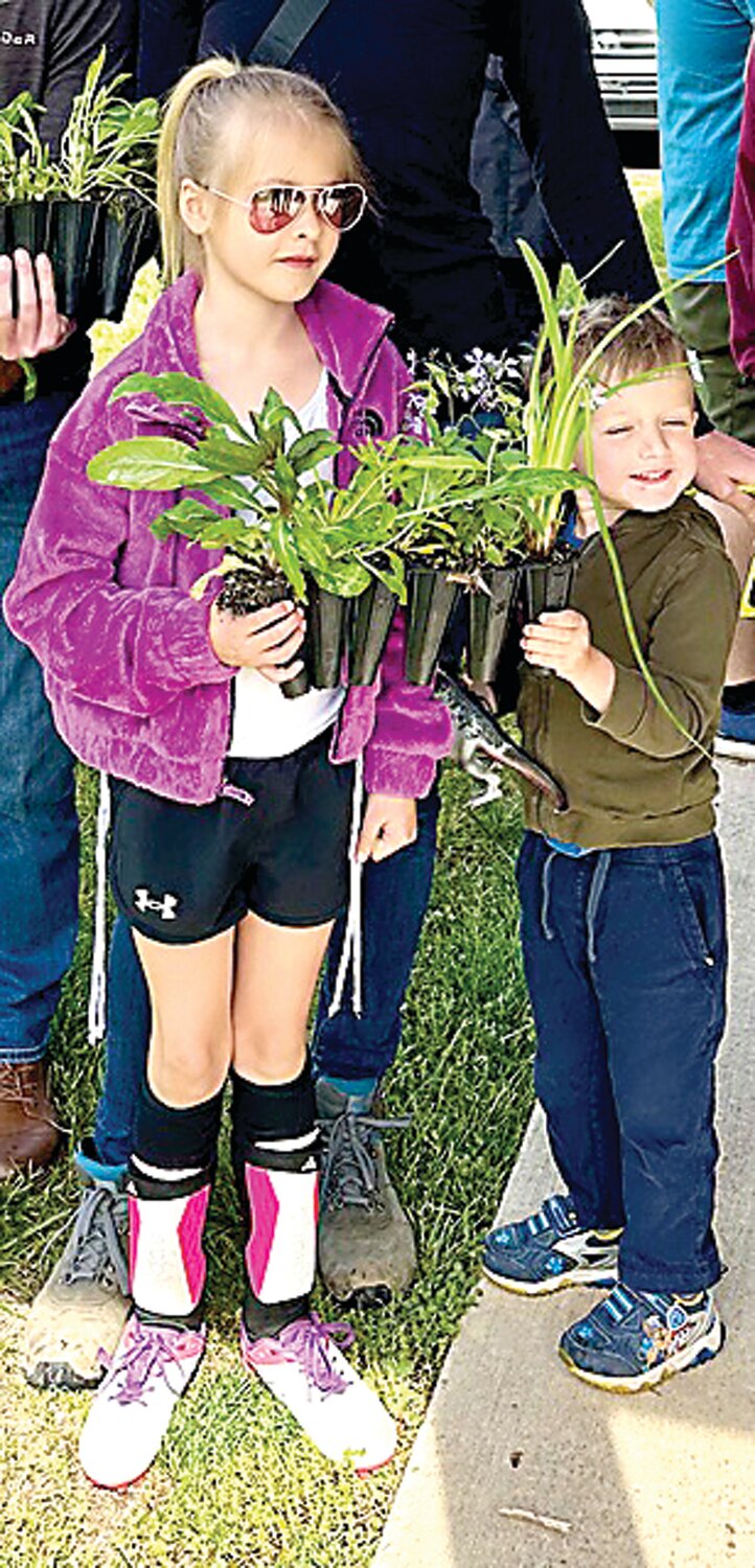 Children hold their selections at the Third Annual Native Plant Sale at Hansell Park Pavilion in Buckingham.
