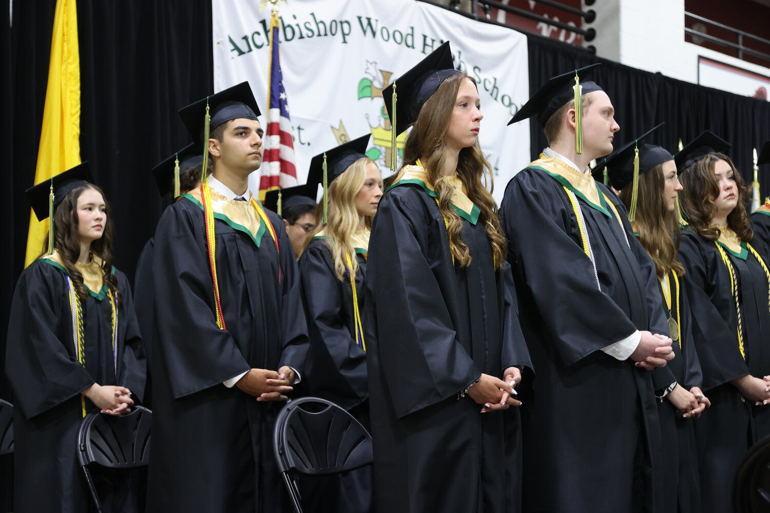 Seniors stand at attention during the Archbishop Wood graduation.