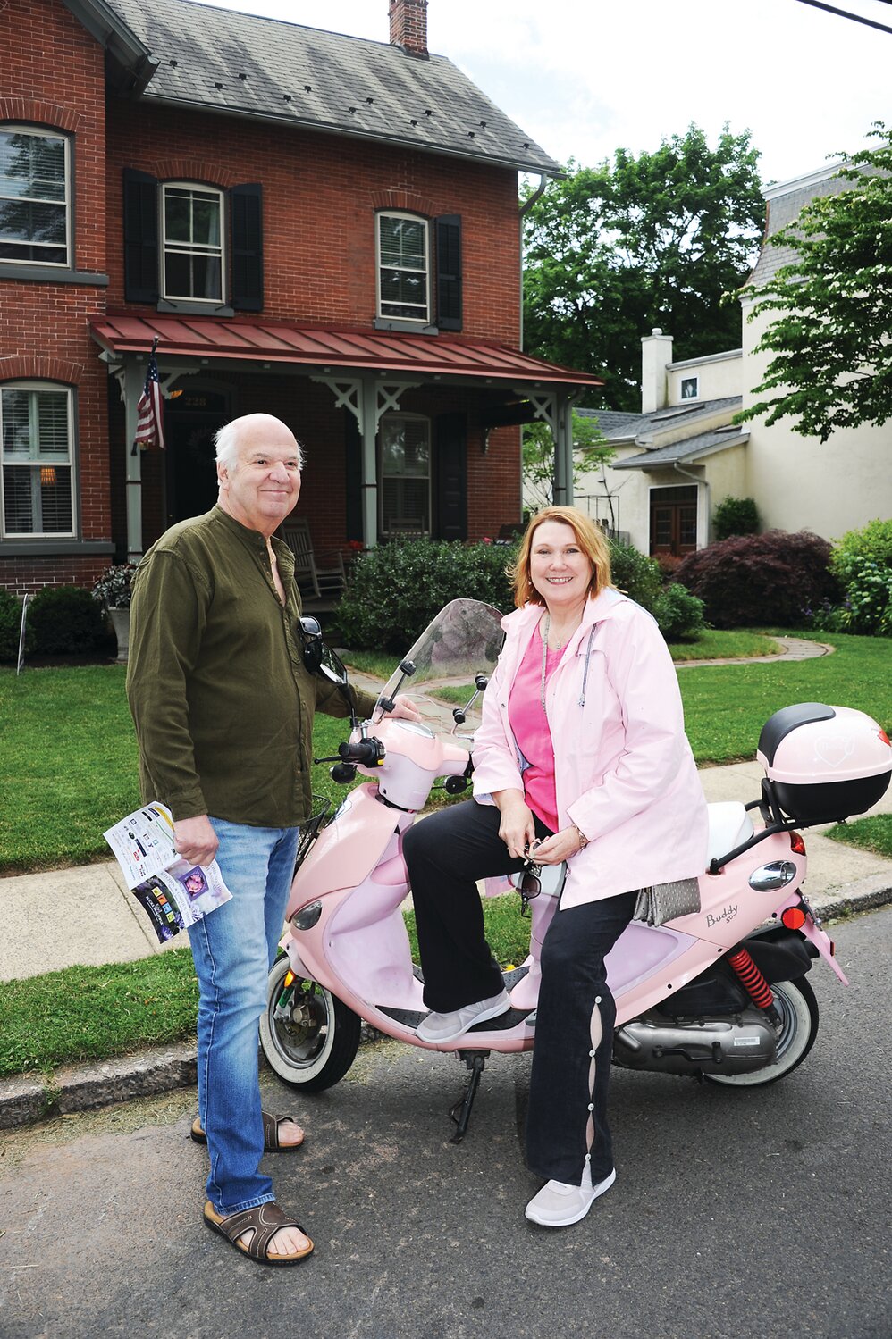 Rich and Donna Guibilo, who traveled the tour on scooters, in front of the Foster residence.