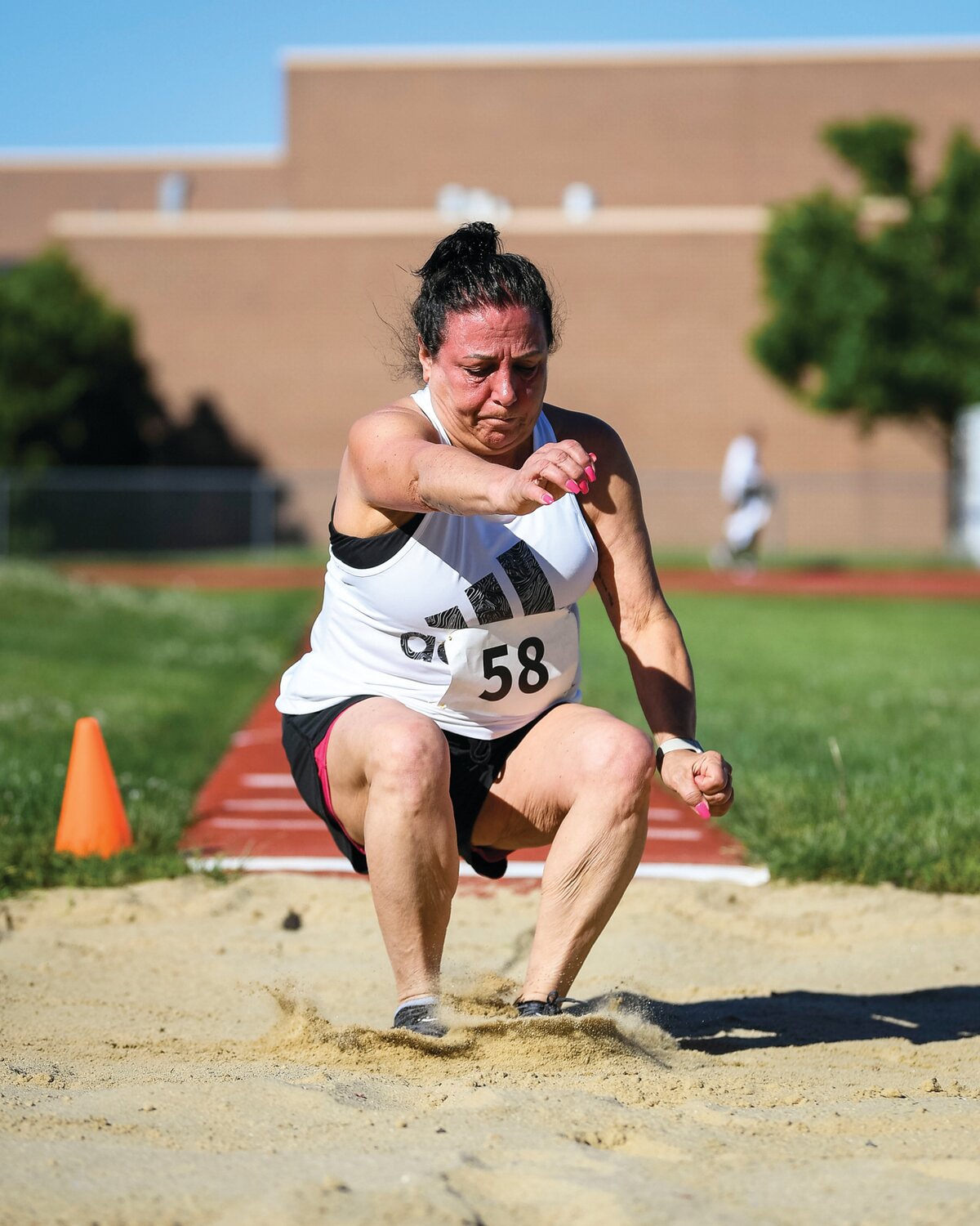 Nancy Scudero lands during her first attempt at the long jump.