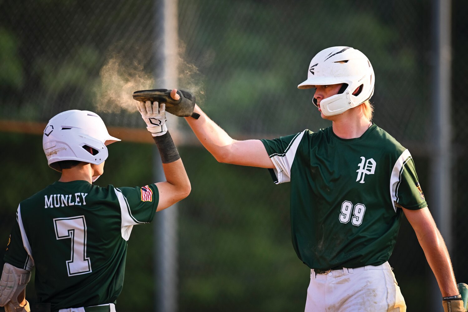Pennridge’s Connor Smith, right, gets a high five from Will Munley after scoring in the four-run second inning.