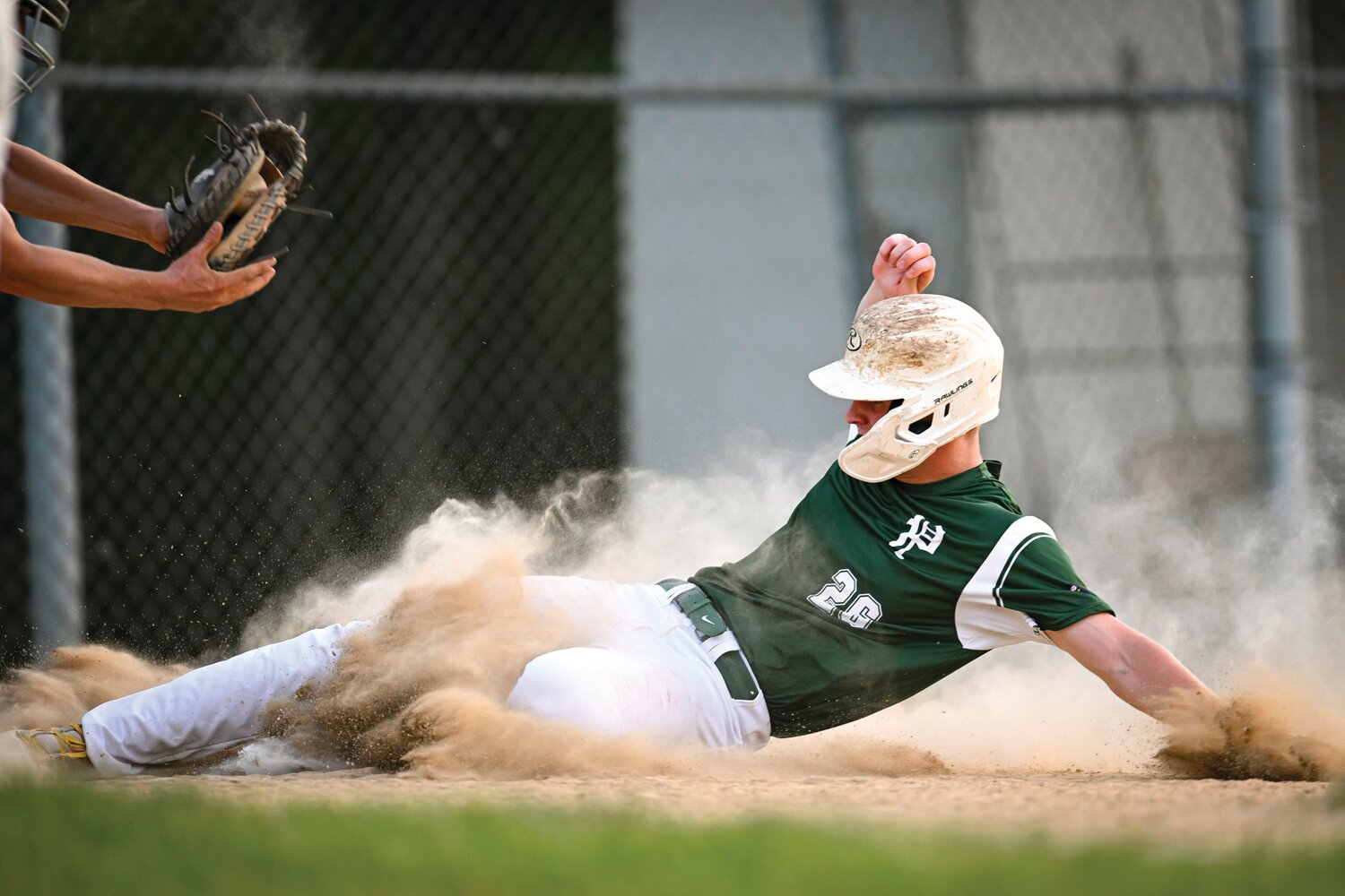 Pennridge’s Zach Swanson slides in at home ahead of the throw during the third inning.
