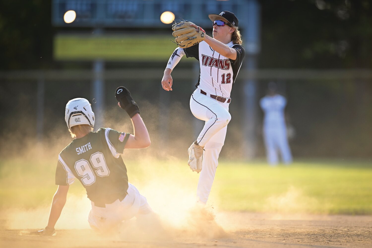 Pennridge’s Connor Smith slides into second base as Hatfield-Towamencin’s Brian Diffley fields the throw in the second inning.