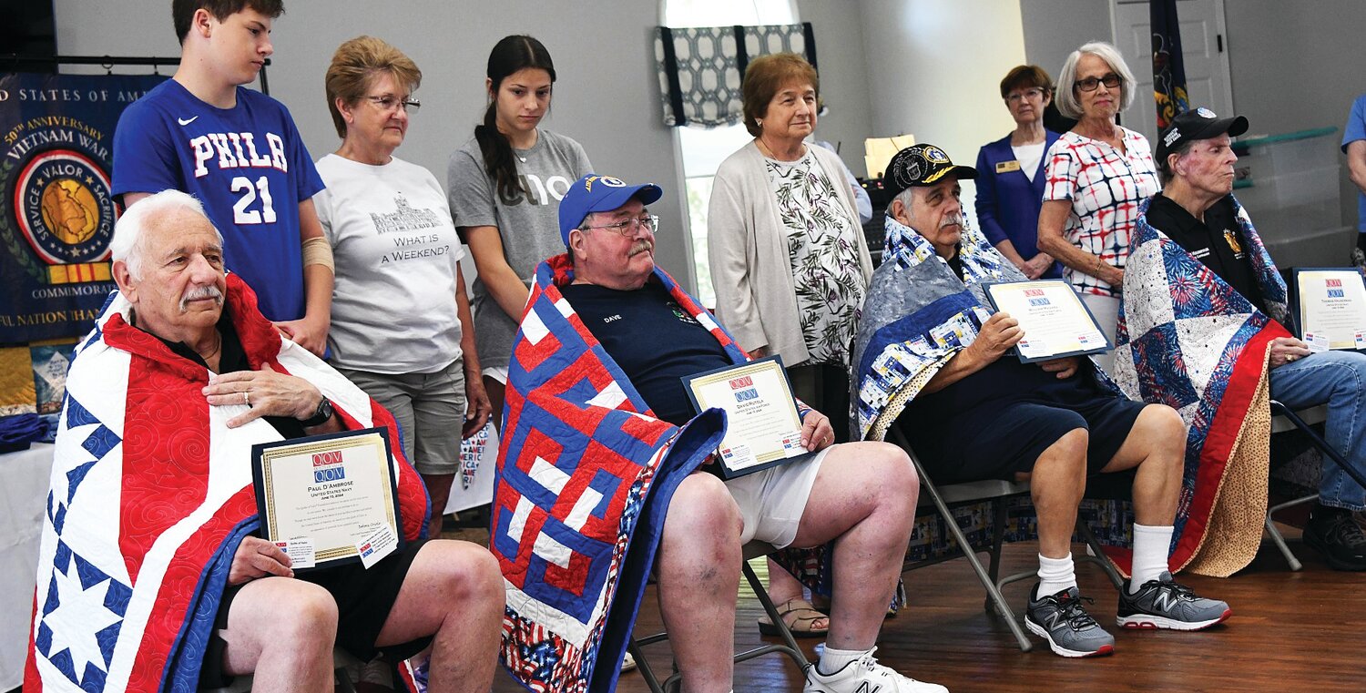 Four of the 47 veterans who received quilts from the Quilts of Valor organization Saturday at the Village of Buckingham Springs.