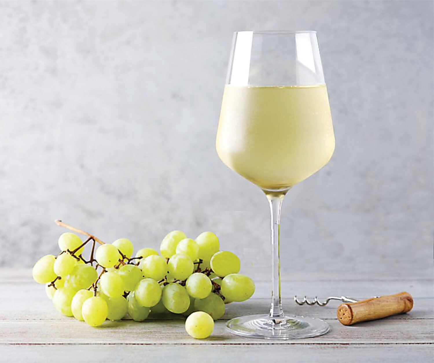 A glass of Sauvignon Blanc and grapes.