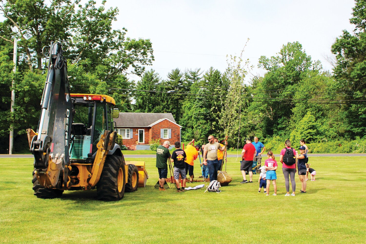Volunteers plant a tree in Hilltown Civic Park during an event hosted by the Hilltown Township Public Works and the Travis Manion Foundation.