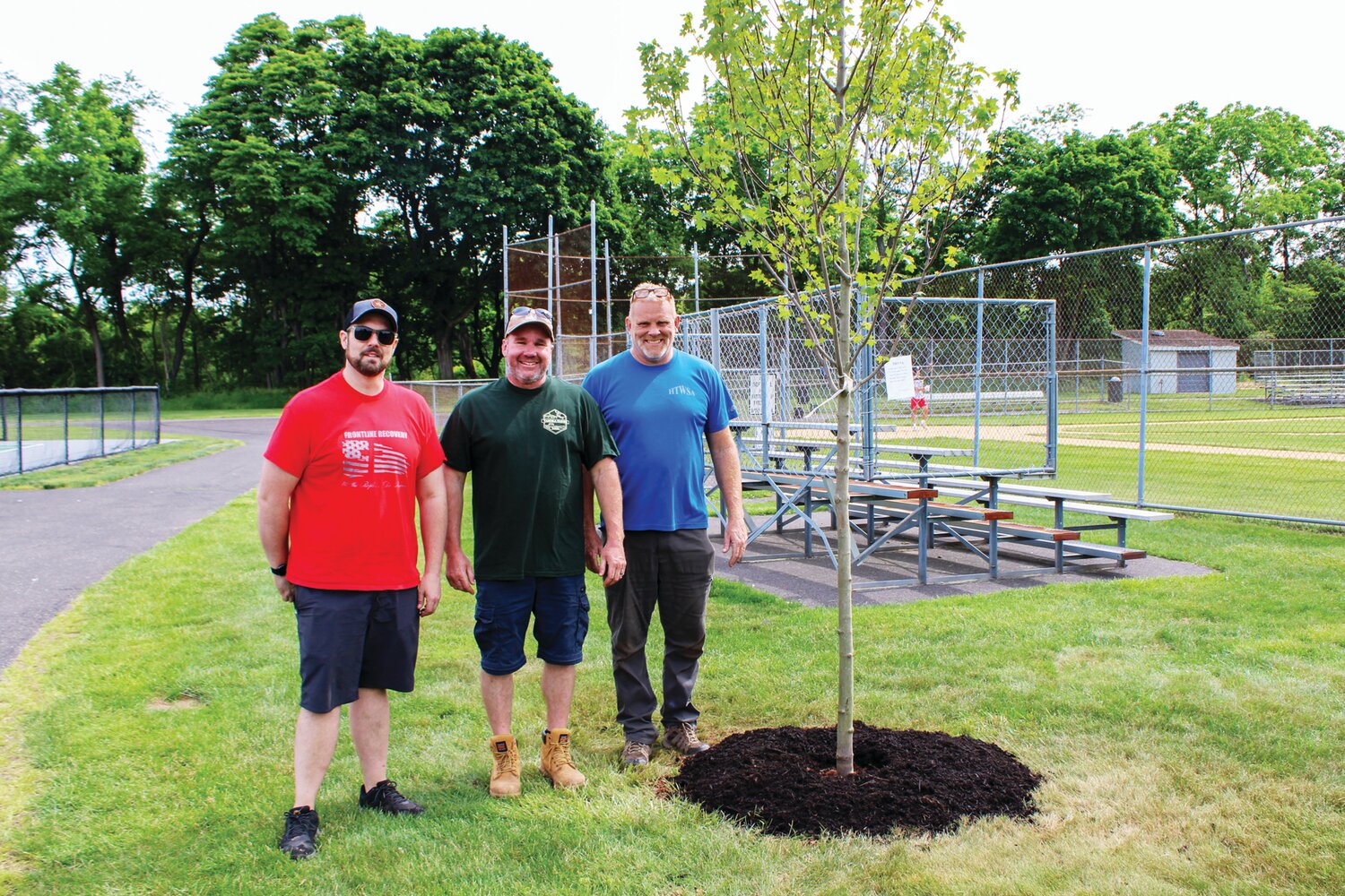 **** Hilltown Township Supervisors Joe Metzinger, Caleb Torrice and Jim Groff stand next to one of the trees planted in Hilltown Civic Park.