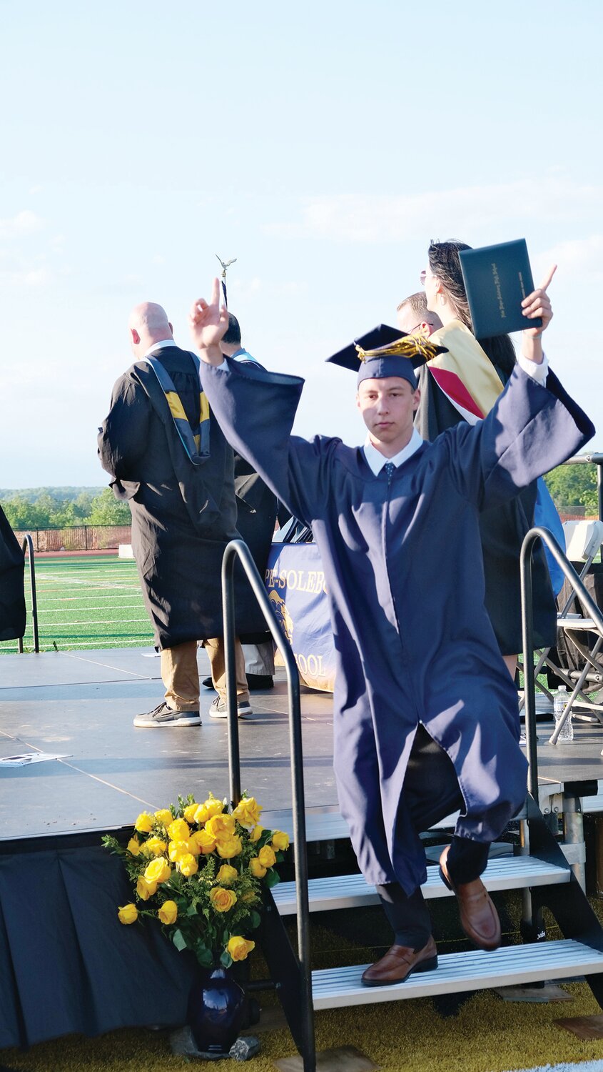 A member of the Class of 2024 celebrates as he exits the stage.